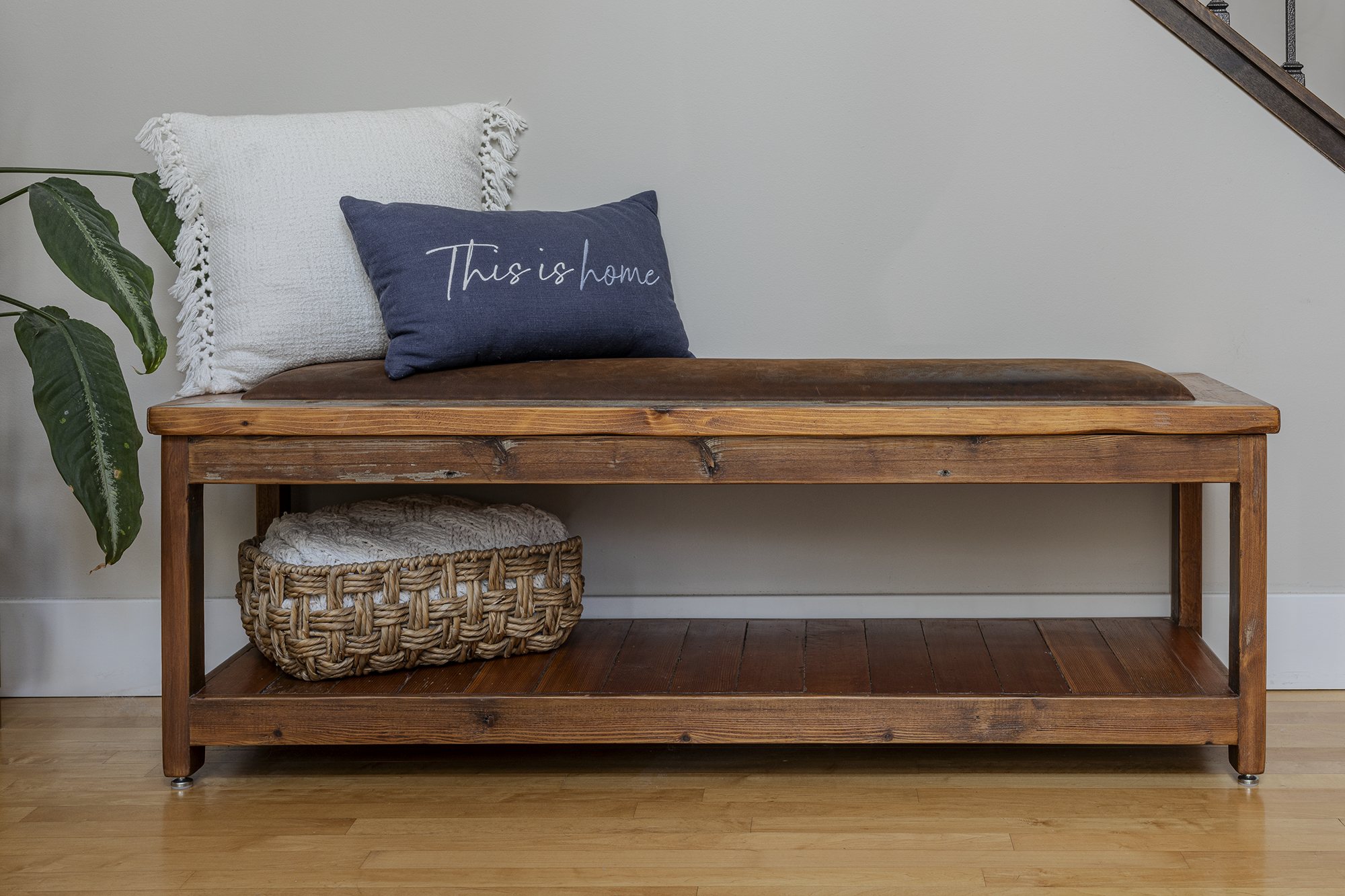A reclaimed wood entry bench and foyer set with hooks and storage