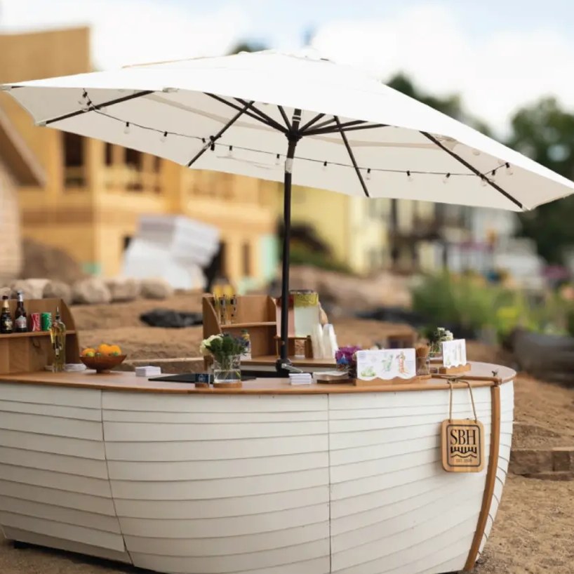 Custom boat bar with umbrella and signature drink menus, a signature rental piece